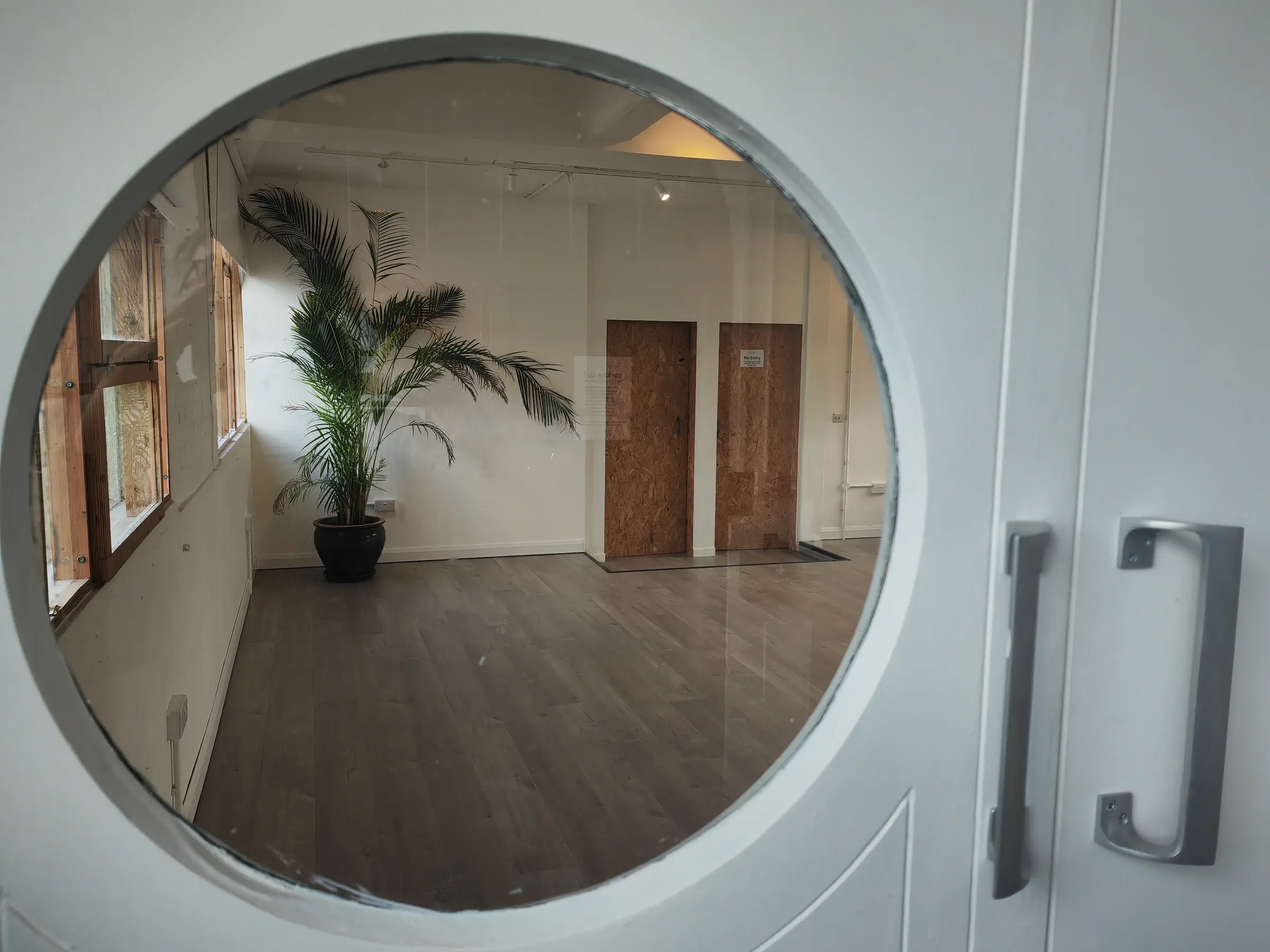 Circle window looking into Studio 49 in the converted Victorian factory on Pixley Street