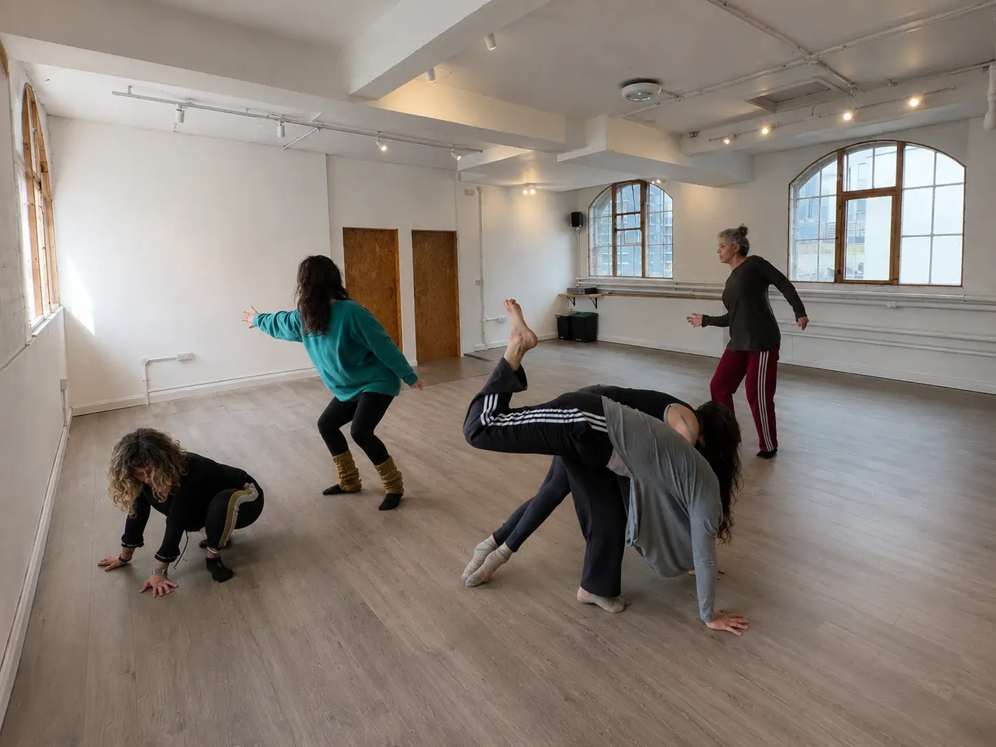 Dancer mid-improvisation on the timber floor of Studio 49